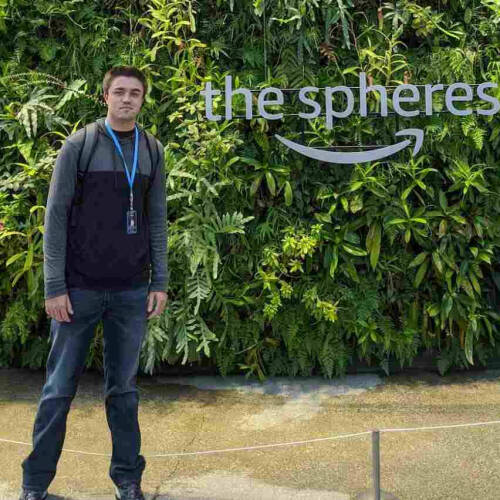 A man stands next to Amazon-the spheres